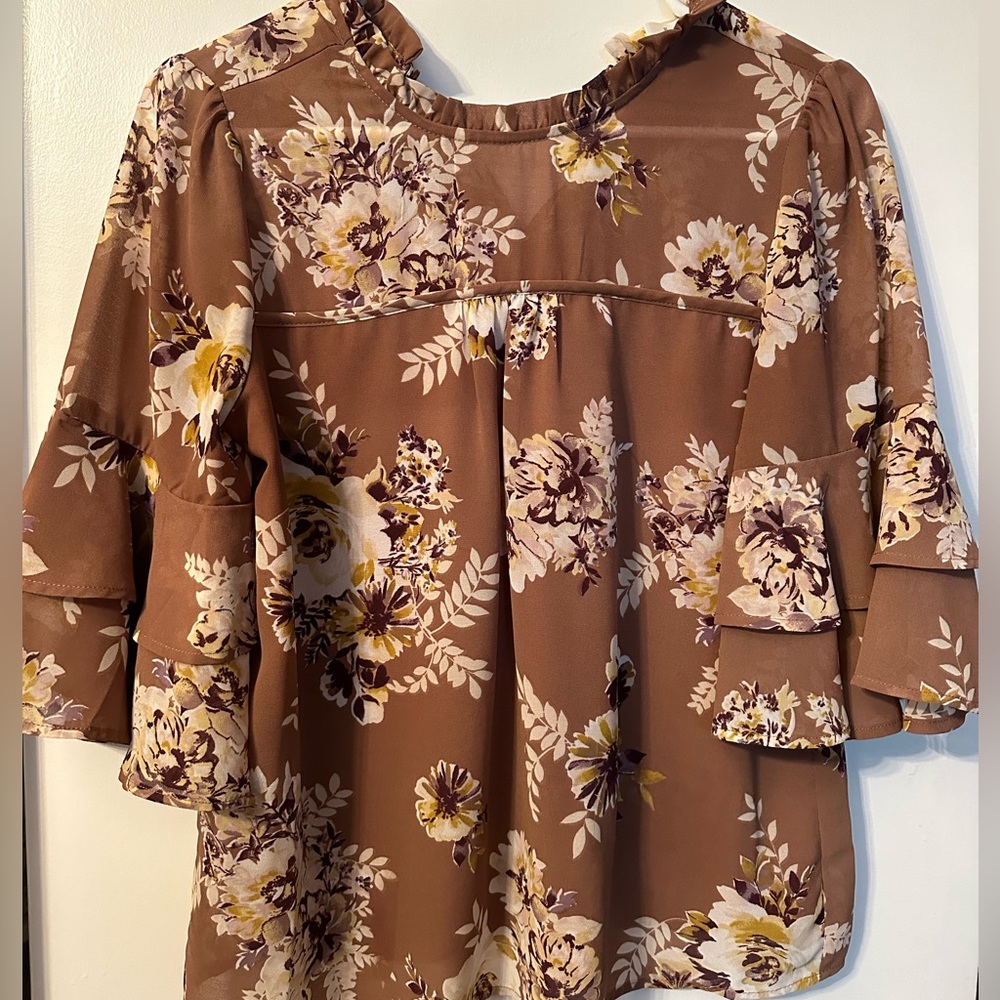 Tan floral blouse, ruffled neckline. Small